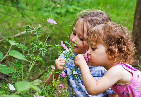 Girls smelling flowers